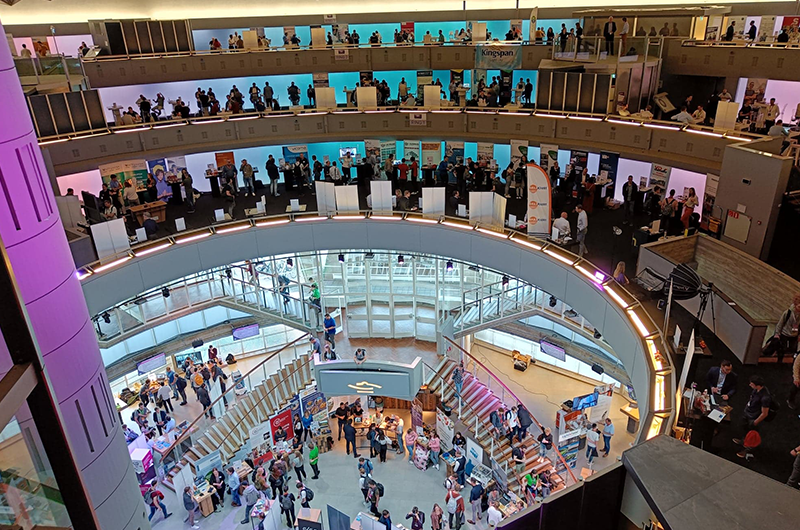 A view of multiple floor levels at a business event where attendees are matched using proprietary AI-driven software for networking purposes.